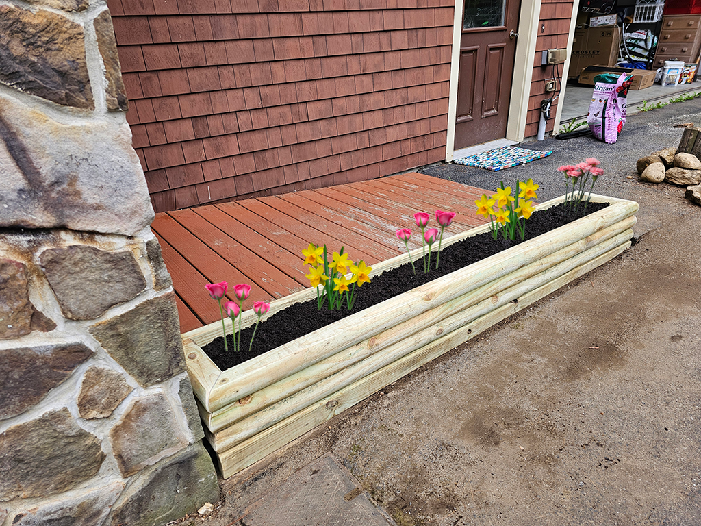 Completed Raised Garden Bed with Soil and Simulated Flowers